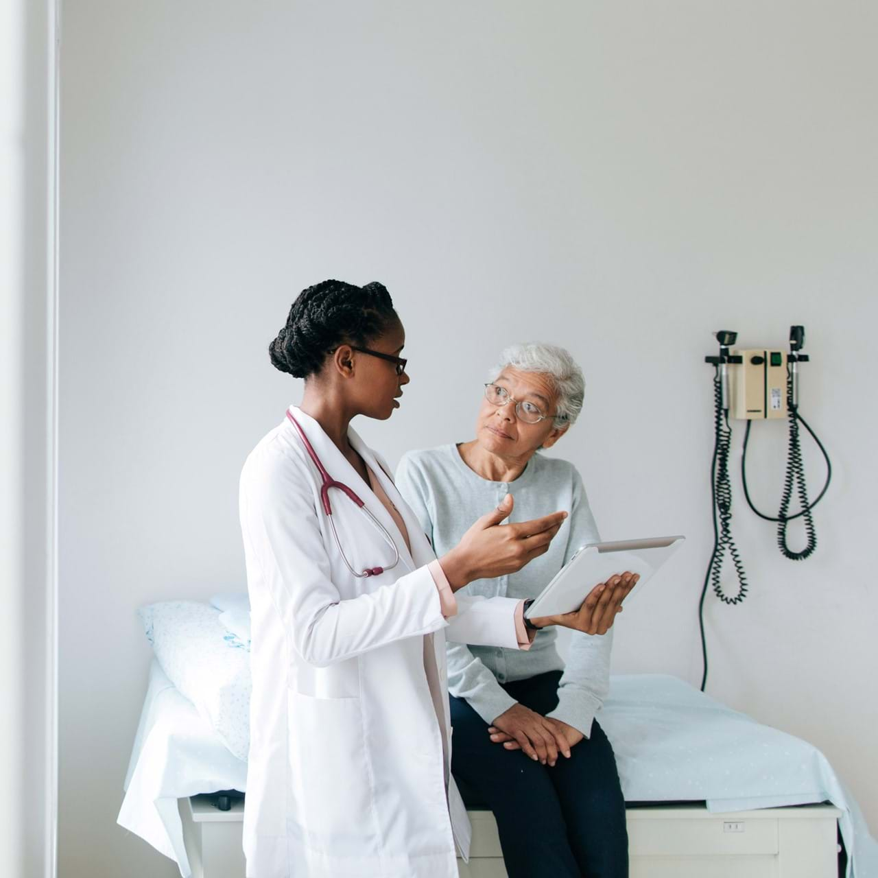 Doctor explaining to elderly patient