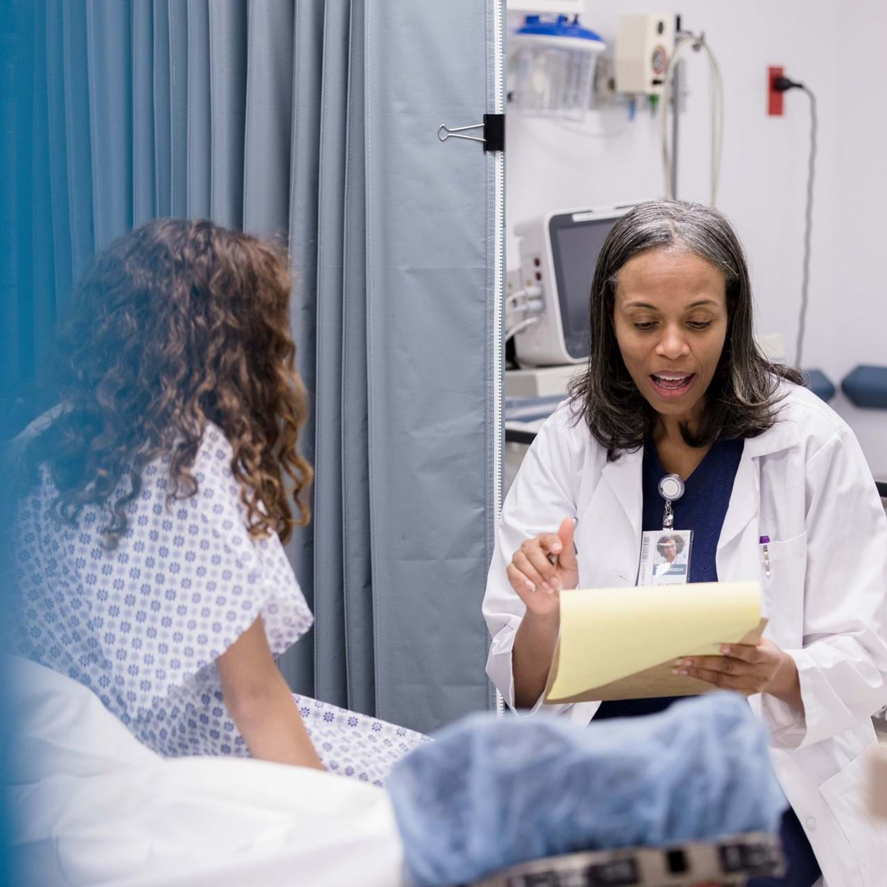 Doctor speaks to patient in emergency room