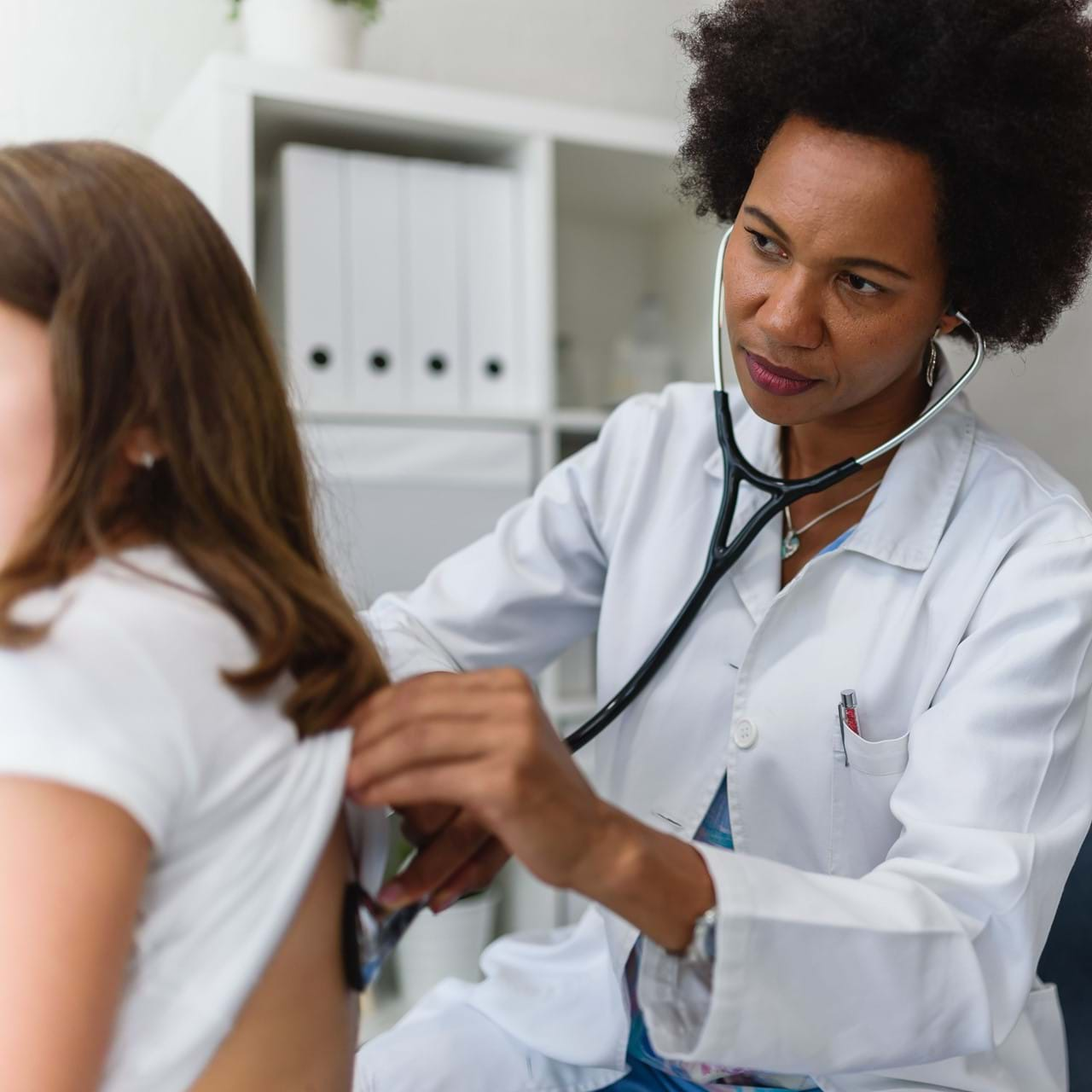 Doctor listening to patient's breathing